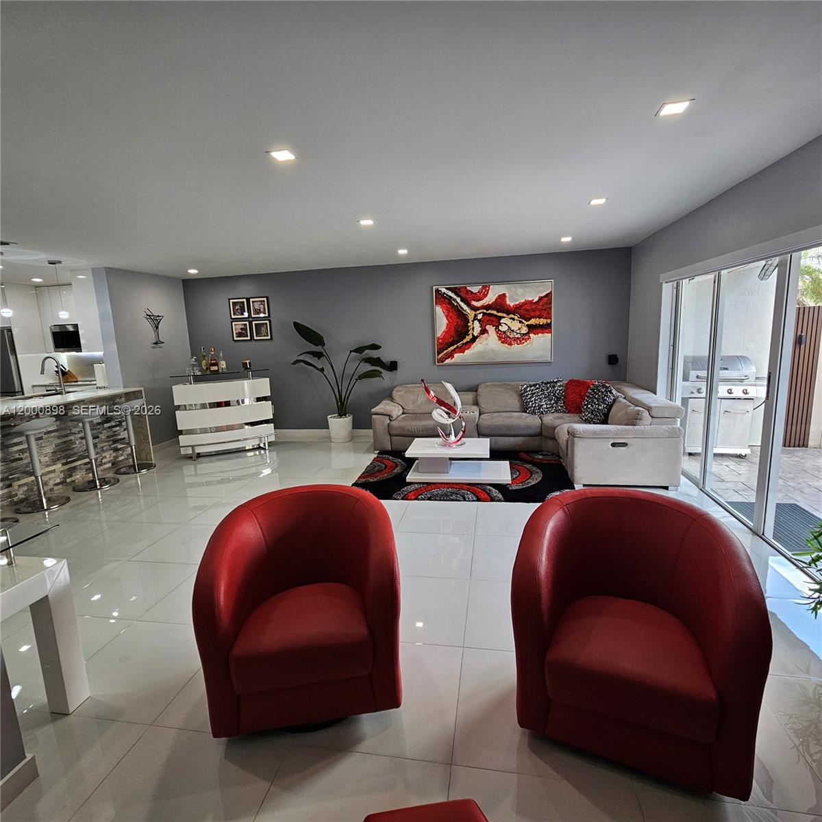 7378 Southwest 162nd Place Miami, FL 33193 - Photo 13 of 37 a living room with furniture and a flat screen tv