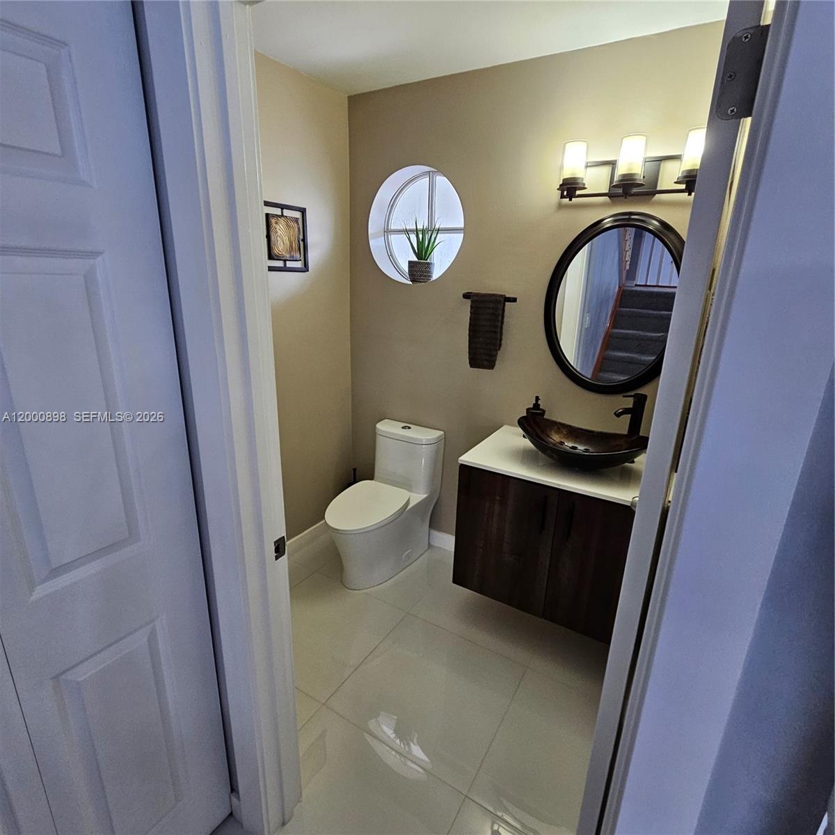 7378 Southwest 162nd Place Miami, FL 33193 - Photo 14 of 37 a front view of a house with washer and dryer