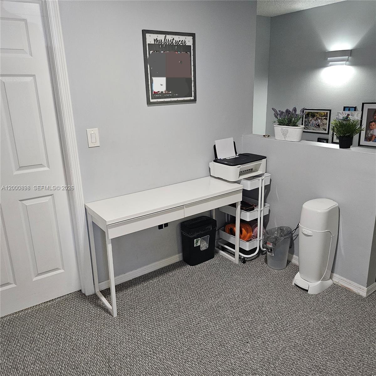 7378 Southwest 162nd Place Miami, FL 33193 - Photo 17 of 37 a room with a chair and white walls