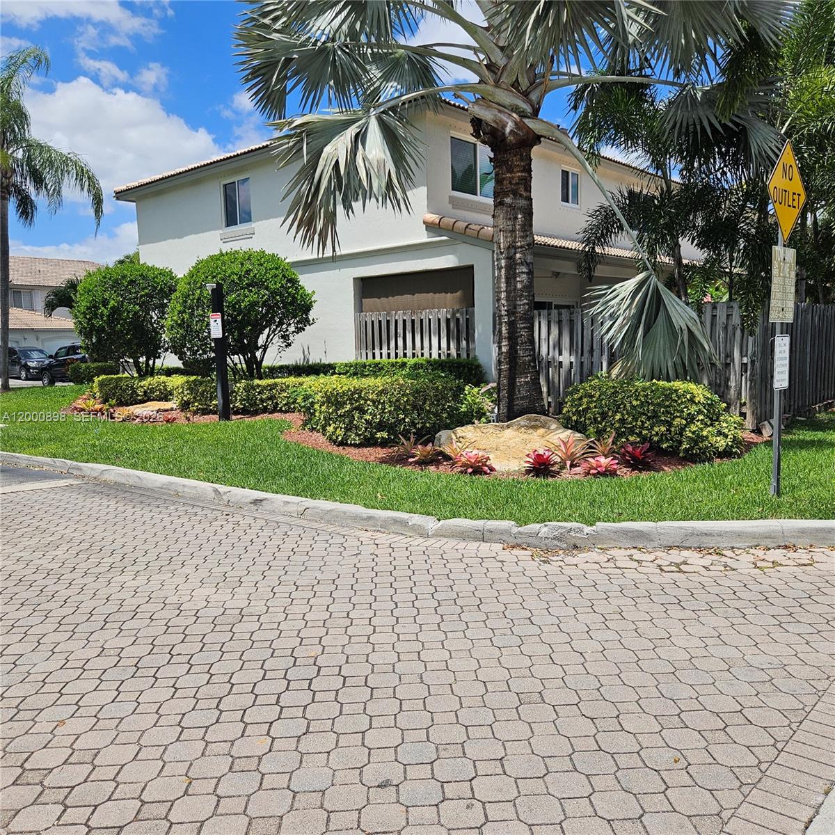 7378 Southwest 162nd Place Miami, FL 33193 - Photo 2 of 37 a front view of a house with a garden