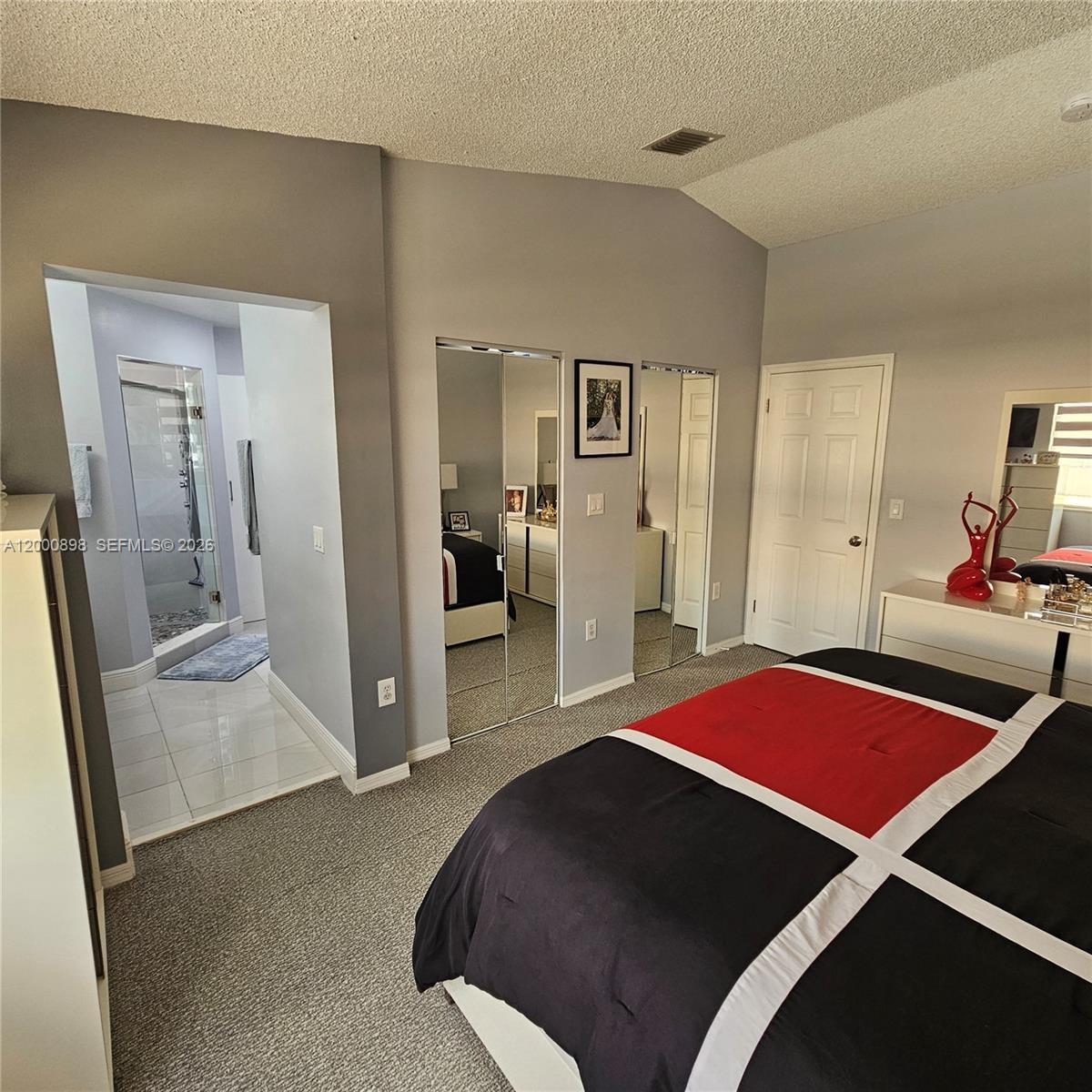 7378 Southwest 162nd Place Miami, FL 33193 - Photo 25 of 37 a bedroom with a bed and a dresser in it