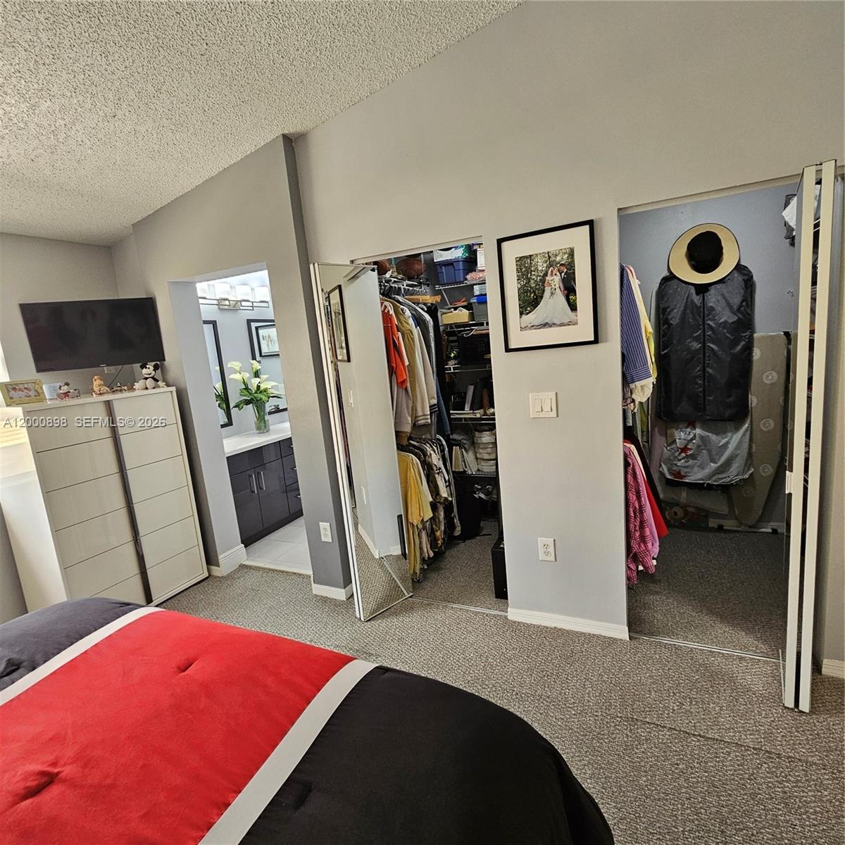 7378 Southwest 162nd Place Miami, FL 33193 - Photo 26 of 37 a bedroom with bed and a mirror
