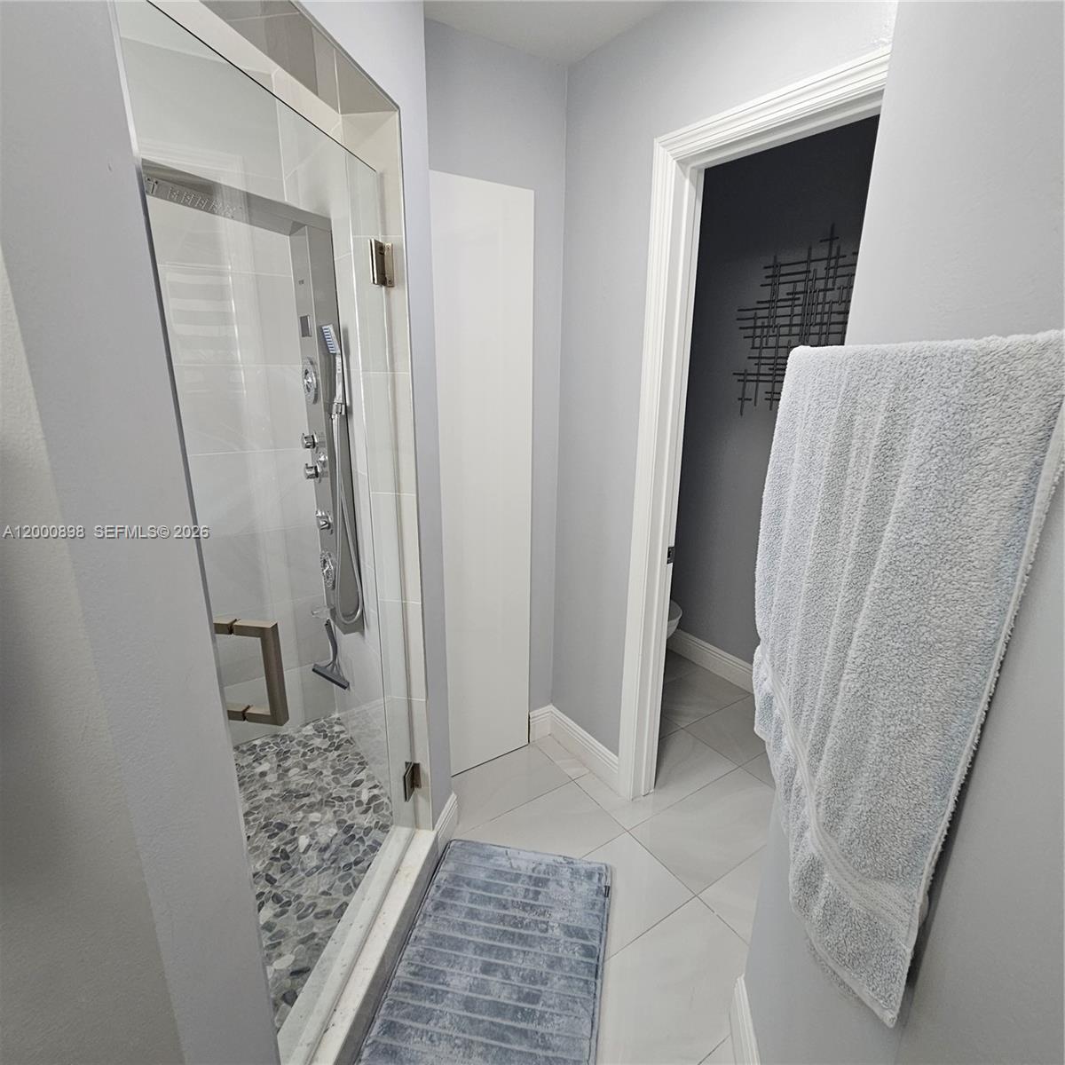 7378 Southwest 162nd Place Miami, FL 33193 - Photo 29 of 37 a view of bathroom with shower and wooden floor