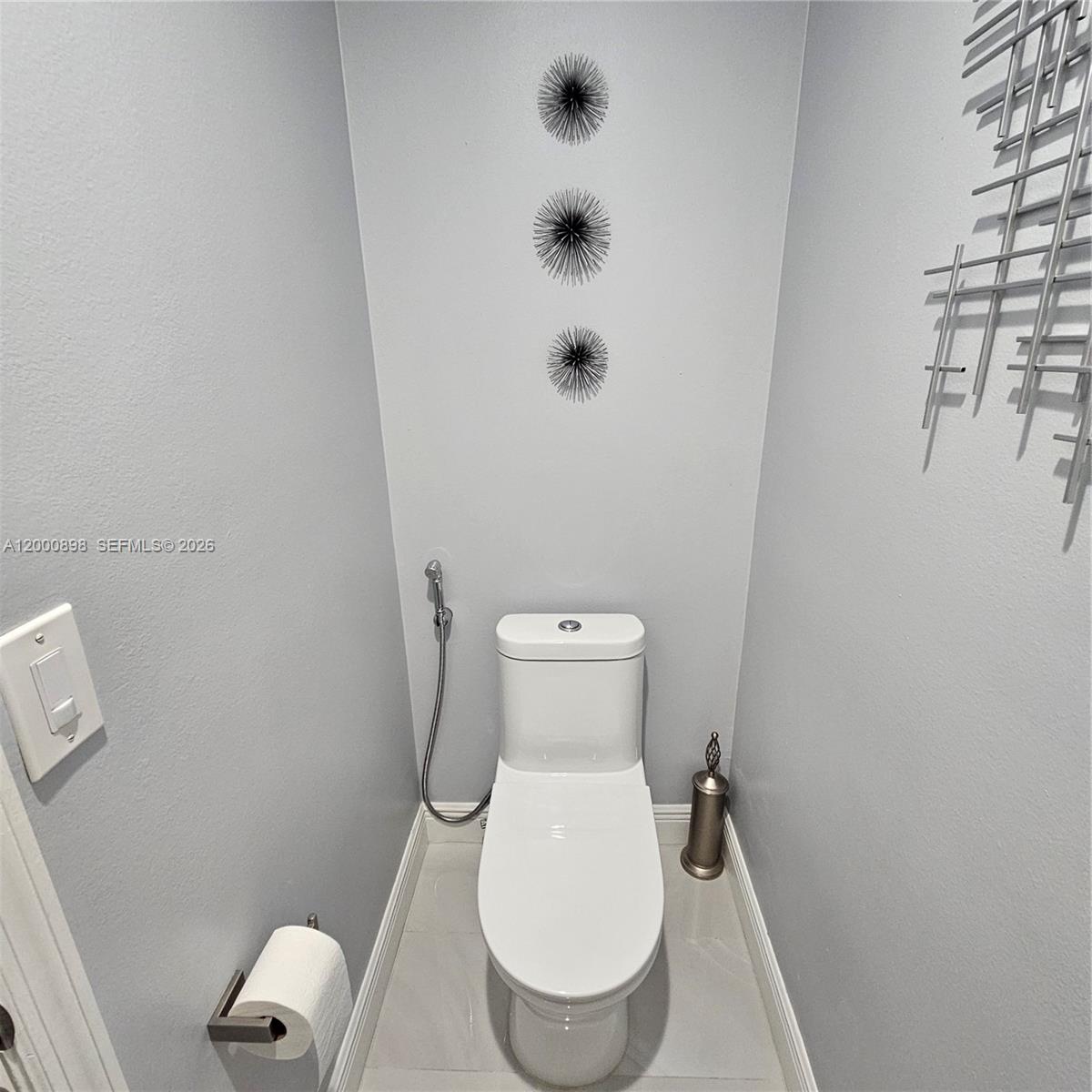 7378 Southwest 162nd Place Miami, FL 33193 - Photo 30 of 37 a white toilet sitting next to a white sink