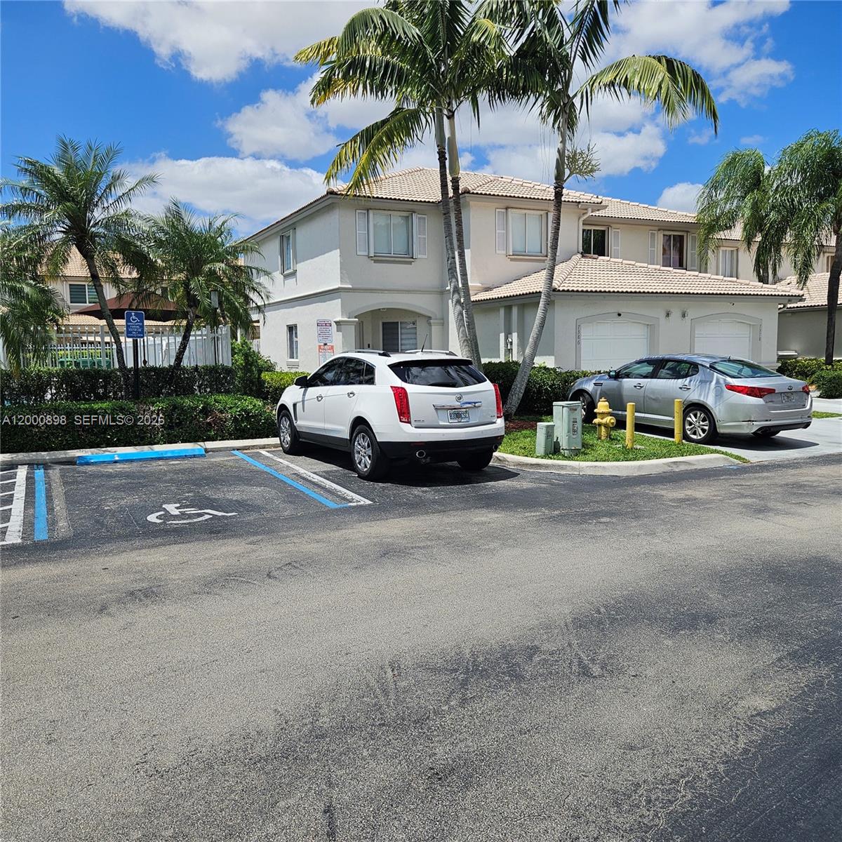 7378 Southwest 162nd Place Miami, FL 33193 - Photo 3 of 37 a view of street with parked cars