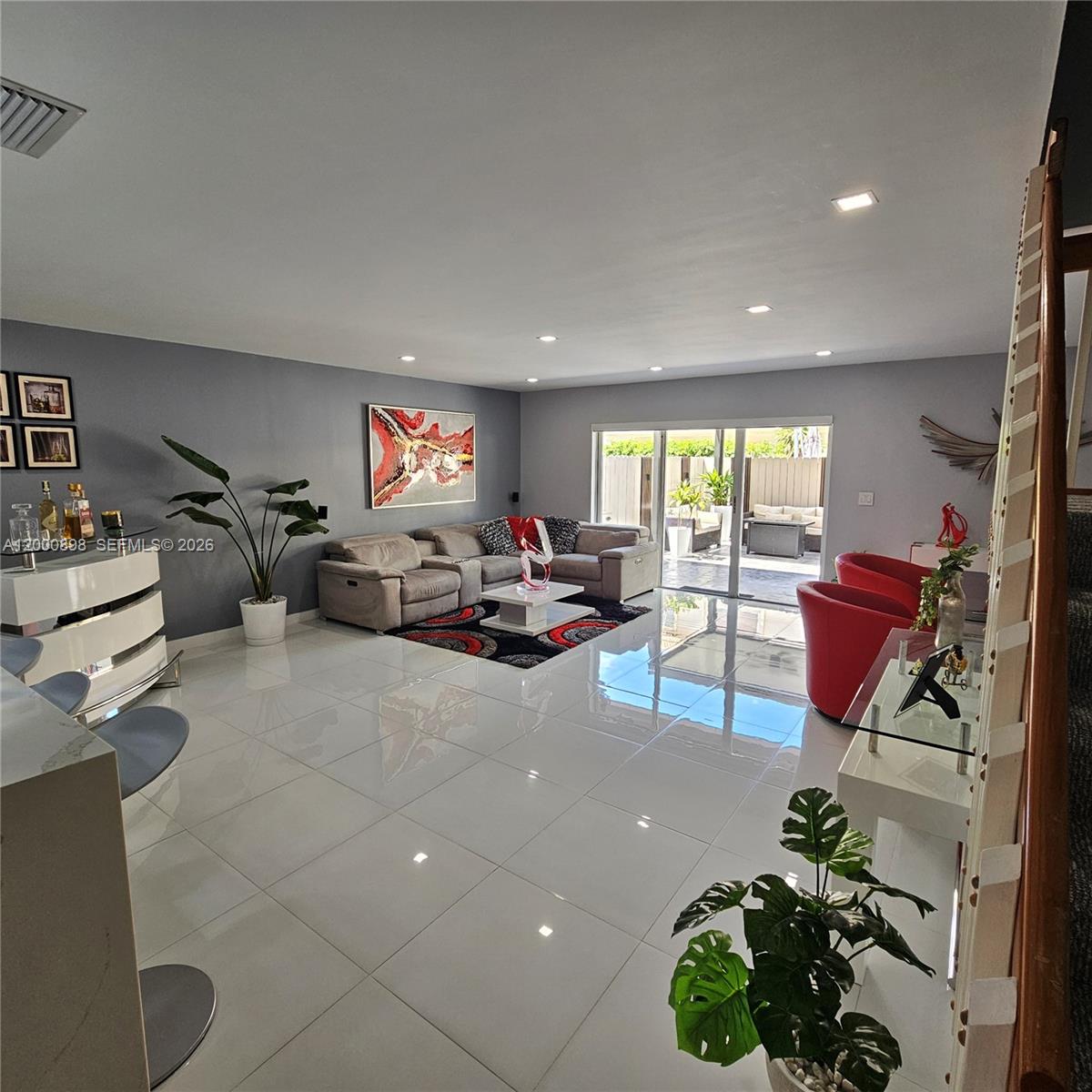 7378 Southwest 162nd Place Miami, FL 33193 - Photo 6 of 37 a living room with furniture and a chandelier