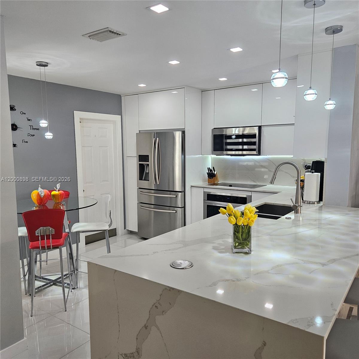7378 Southwest 162nd Place Miami, FL 33193 - Photo 7 of 37 a kitchen with a sink stainless steel appliances and refrigerator