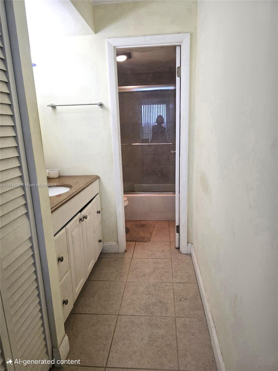 3821 Environ Boulevard, Unit 610 Lauderhill, FL 33319 - Photo 7 of 19 a bathroom with a sink a toilet and a shower