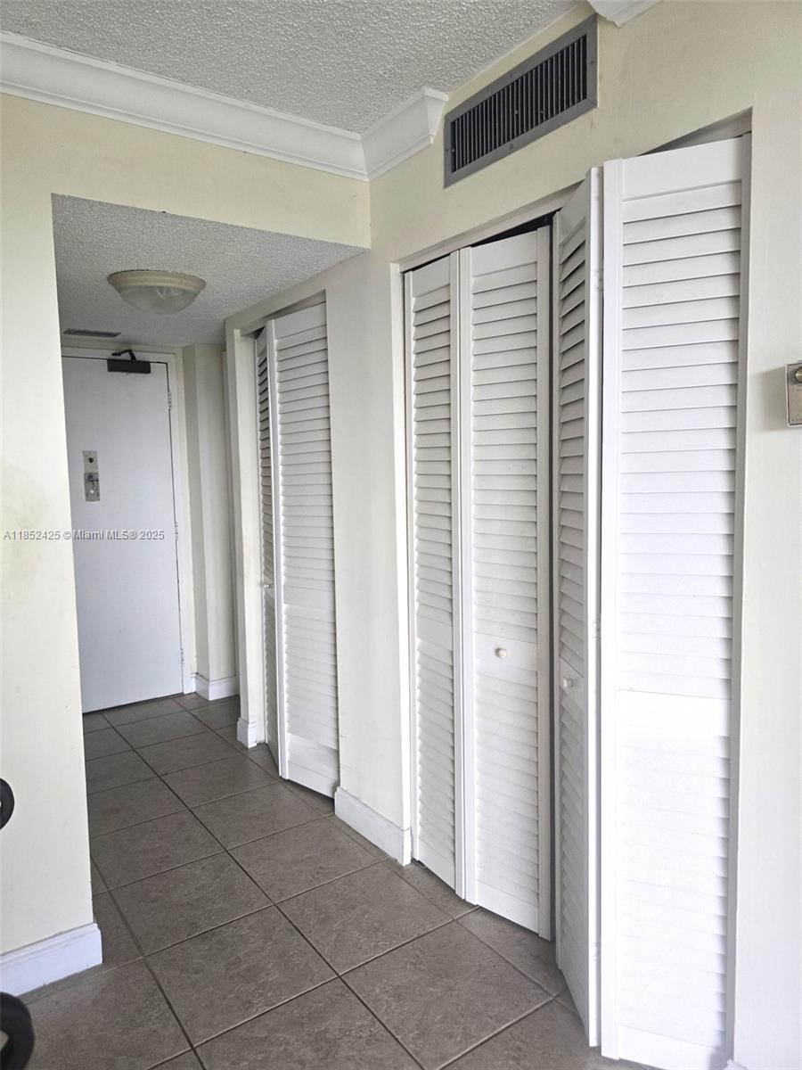3821 Environ Boulevard, Unit 610 Lauderhill, FL 33319 - Photo 9 of 19 a view of a hallway with wooden shelves
