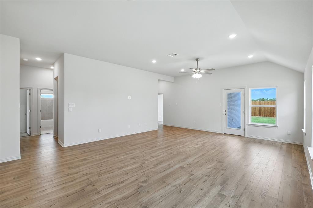 3704 Pitchfork Terrace Anna, TX 75409 - Photo 12 of 31 a view of an empty room with wooden floor and a window