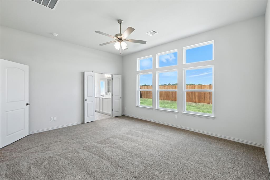 3704 Pitchfork Terrace Anna, TX 75409 - Photo 15 of 31 an empty room with chandelier fan and windows