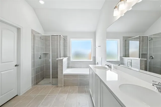 a bathroom with a tub sink and mirror