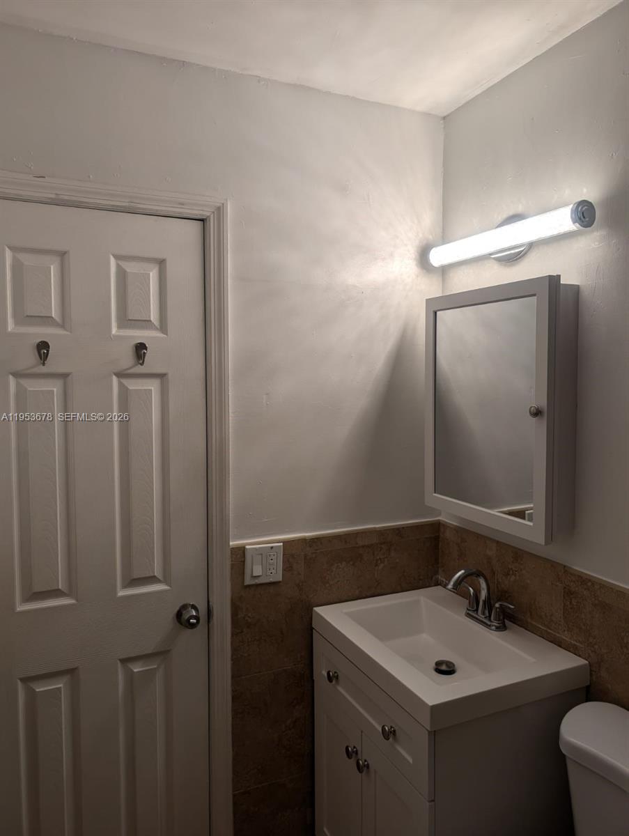 2355 Northwest 9th Street Miami, FL 33125 - Photo 14 of 16 a bathroom with a sink and a toilet