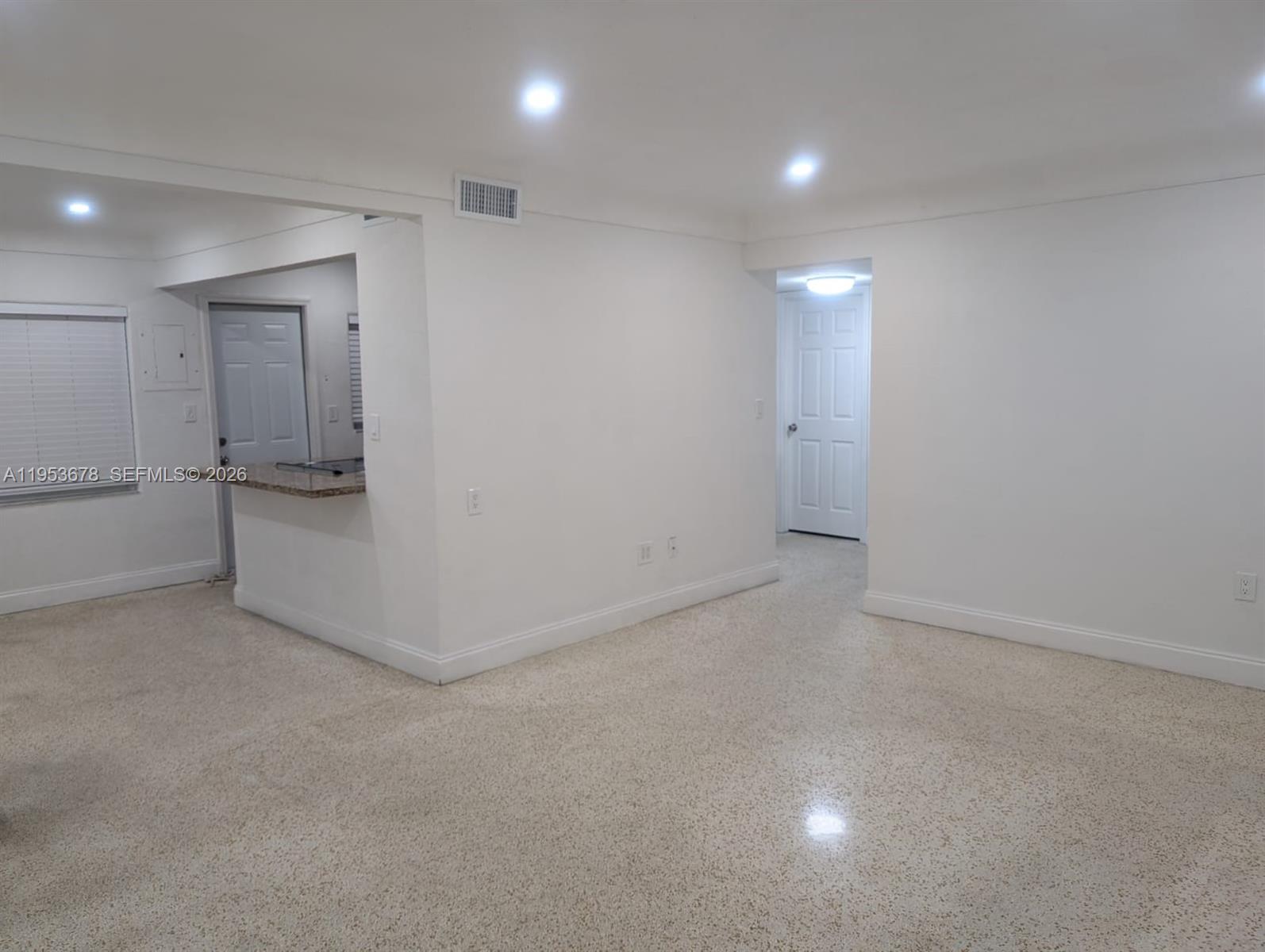 2355 Northwest 9th Street Miami, FL 33125 - Photo 3 of 16 an empty room with white cabinet and a refrigerator