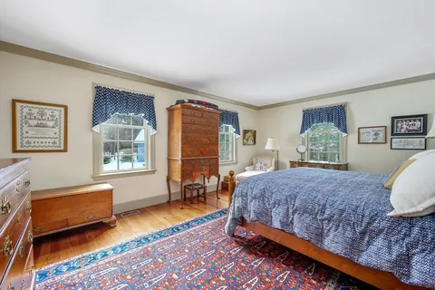 a bedroom with a bed chair and a window
