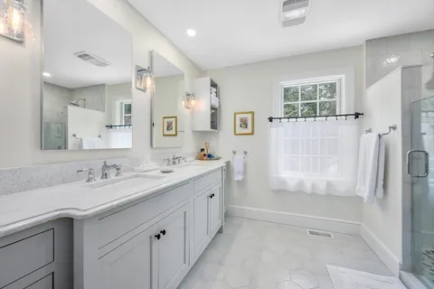 a bathroom with a granite countertop sink mirror bathtub and shower