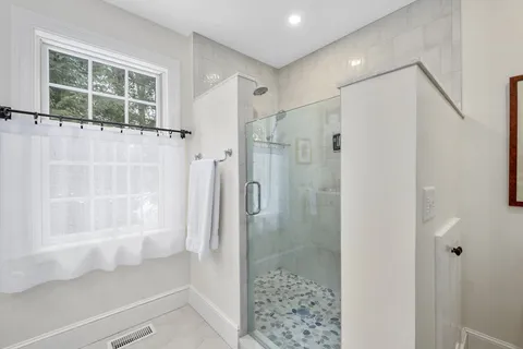 a bathroom with a shower and a glass door
