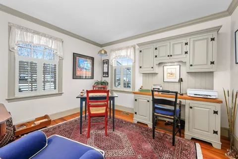 a room with furniture a desk and chair with windows