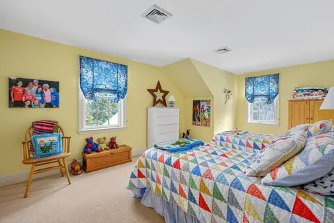 a bedroom that has a bed and a dresser in it