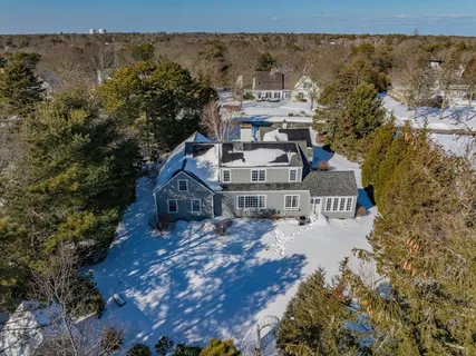 an aerial view of a house with a yard
