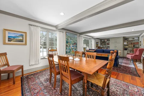 a dining room with furniture and wooden floor