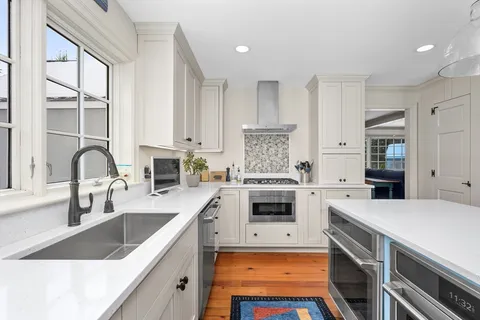 a kitchen with a stove a sink and a refrigerator