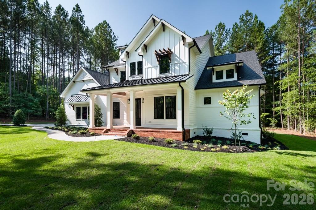 116 Silver Falls Road Troutman, NC 28166 - Photo 3 of 46 a front view of house with yard and green space