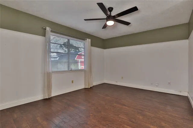a view of an empty room with a fan