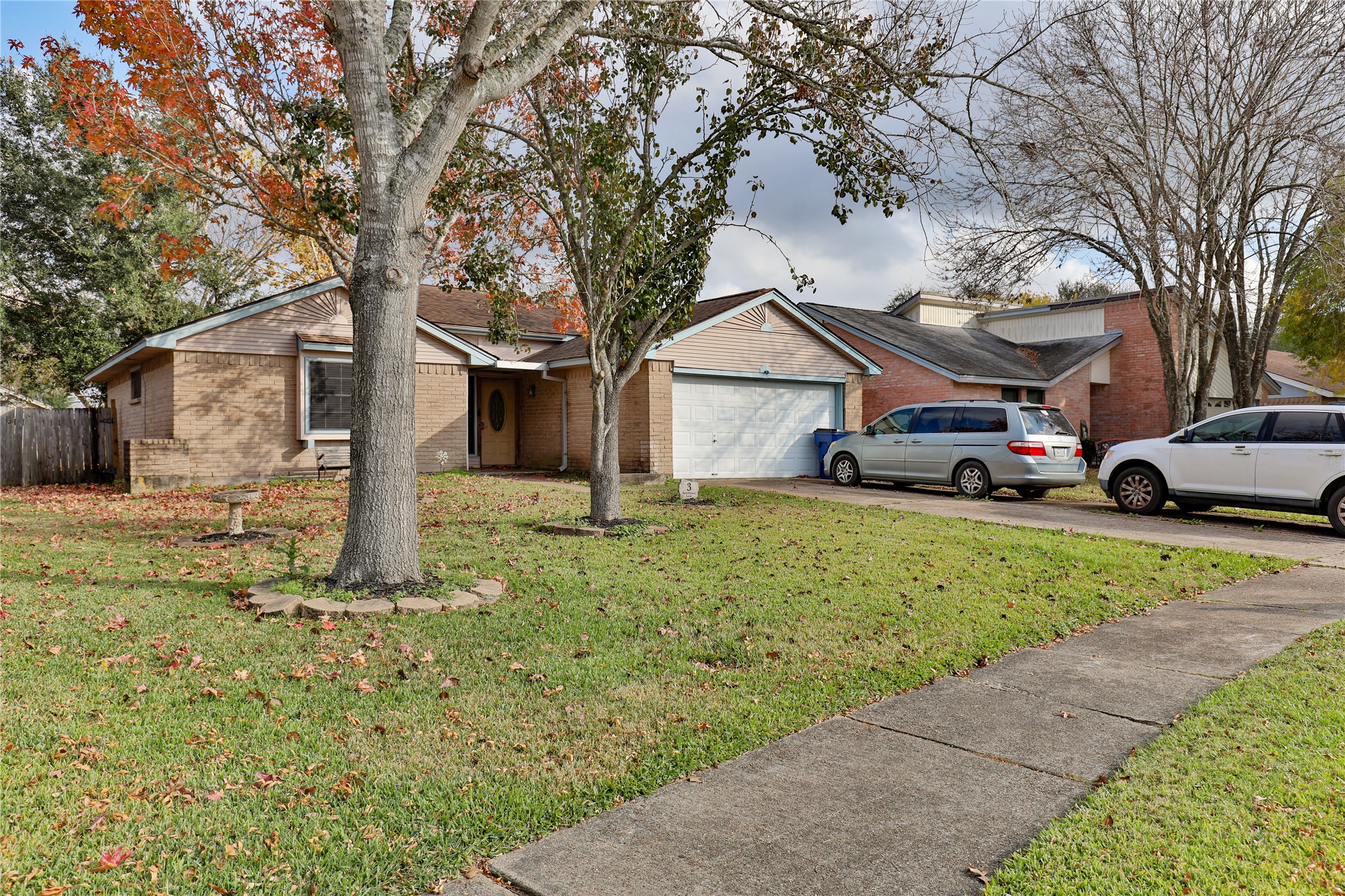 3 Ranch House Loop Angleton, TX 77515 - Photo 2 of 25 a front view of a house with a yard and garage