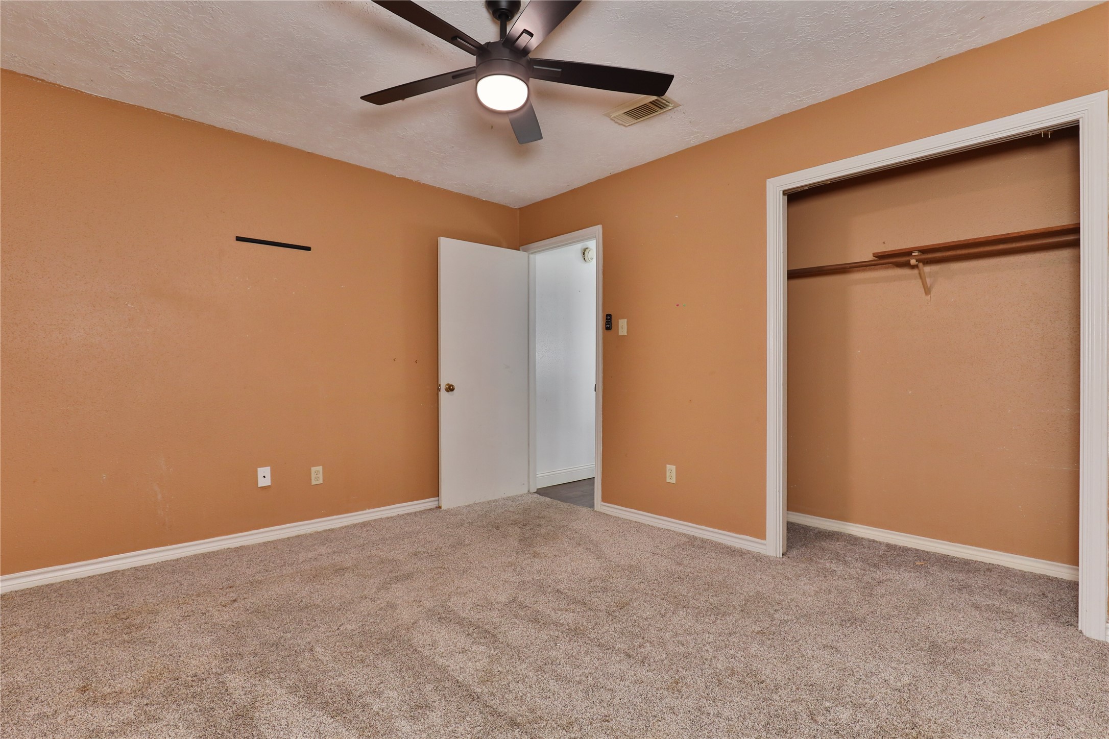 3 Ranch House Loop Angleton, TX 77515 - Photo 23 of 25 an empty room and closet area with a fan