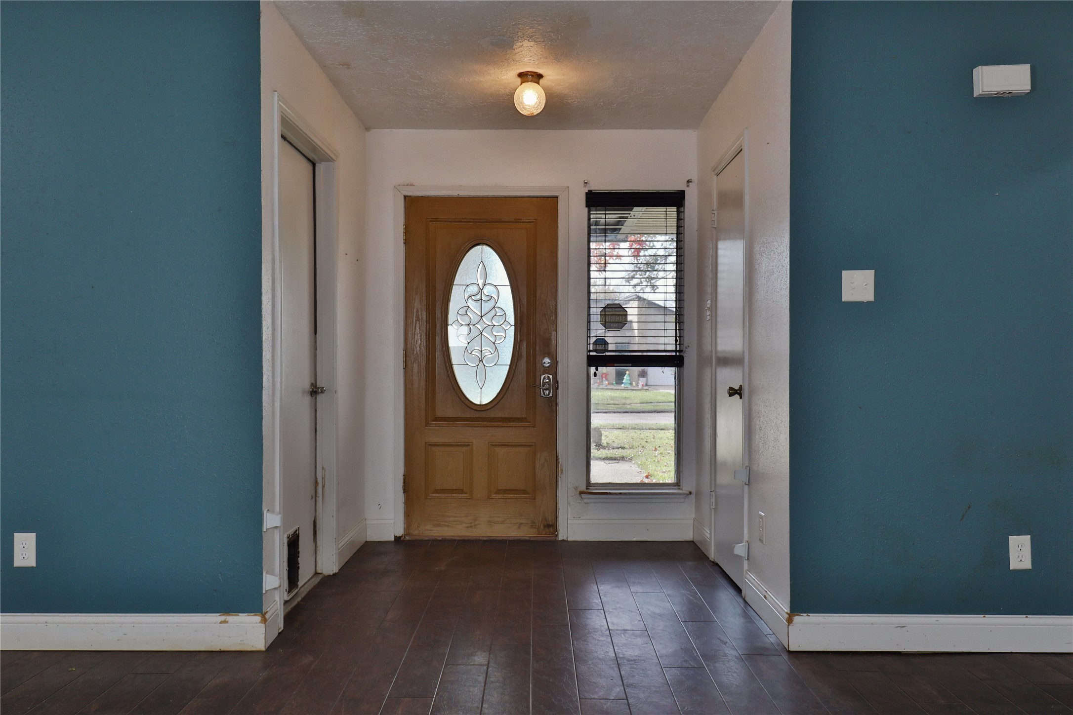 3 Ranch House Loop Angleton, TX 77515 - Photo 3 of 25 an empty room with wooden floor mirror and windows