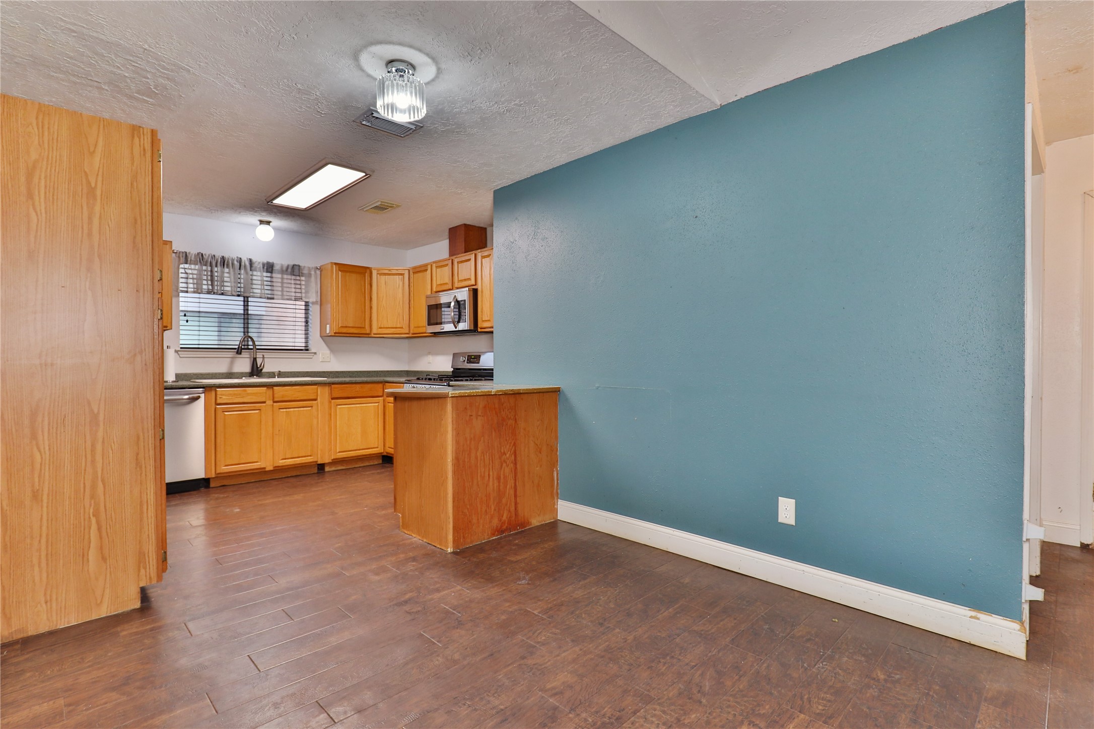 3 Ranch House Loop Angleton, TX 77515 - Photo 8 of 25 a kitchen with granite countertop a sink and a stove top oven
