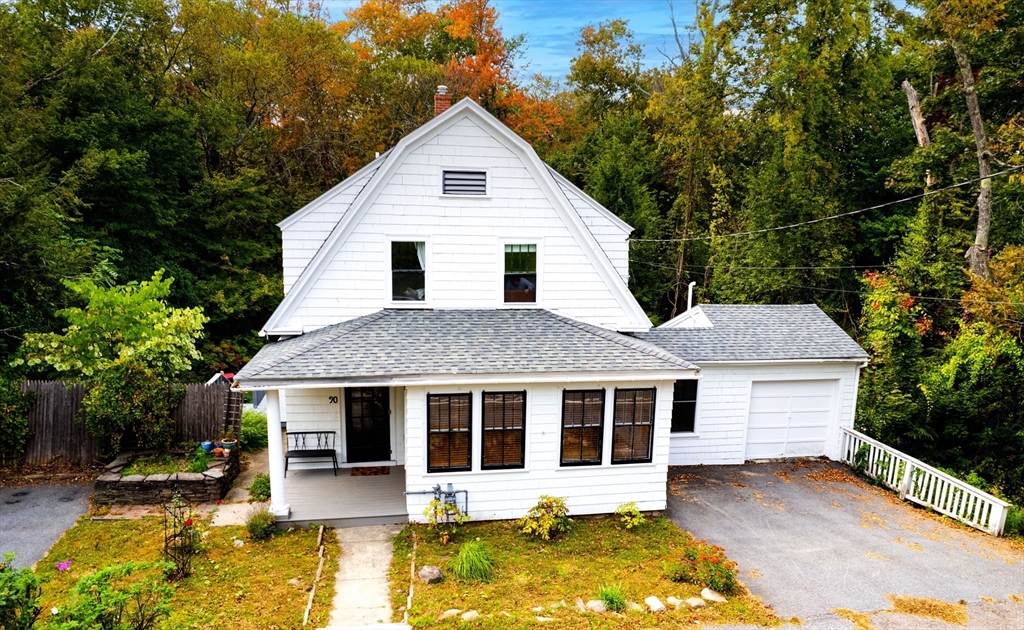 90 Main Street Acton, MA 01720 - Photo 1 of 38 a front view of a house with a yard table and chairs