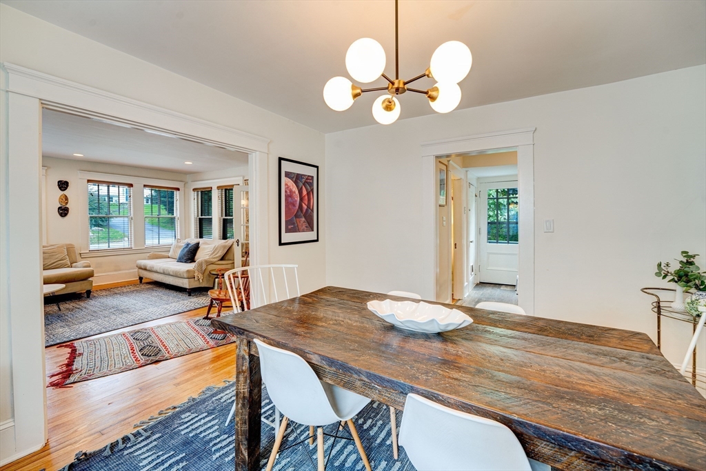 90 Main Street Acton, MA 01720 - Photo 11 of 38 a view of a dining room with furniture a chandelier and wooden floor