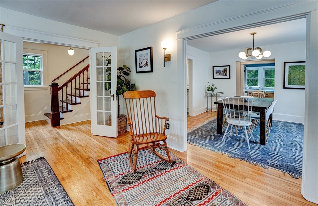 90 Main Street Acton, MA 01720 - Photo 12 of 38 a living room with furniture and a dining table with wooden floor