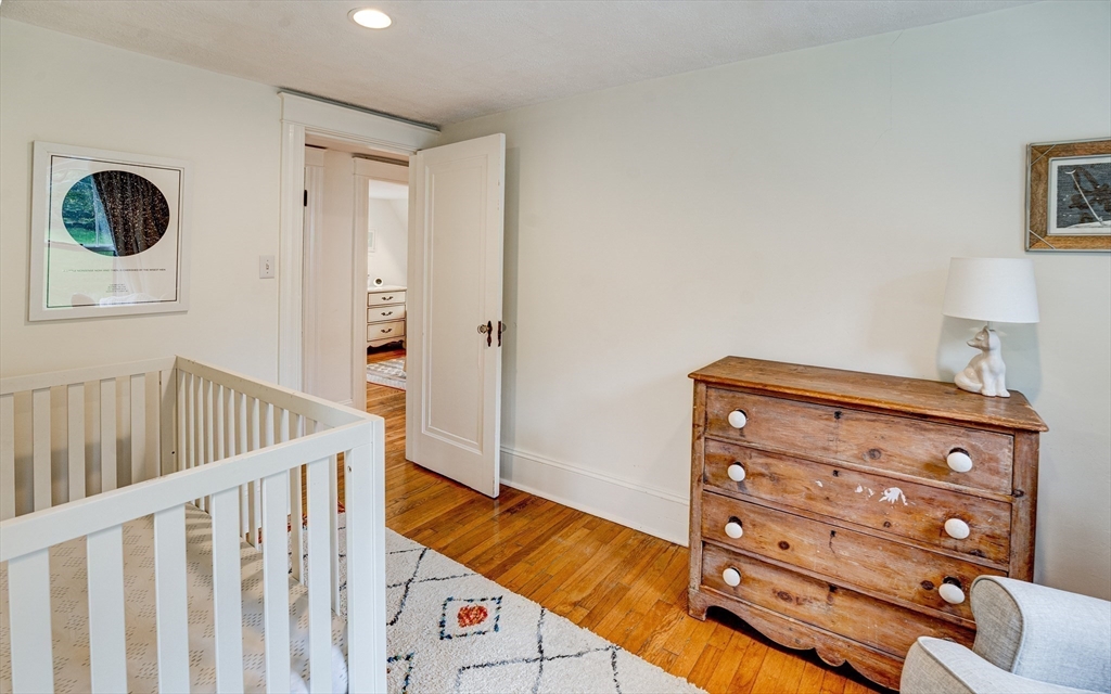 90 Main Street Acton, MA 01720 - Photo 23 of 38 a view of a bedroom with baby crib
