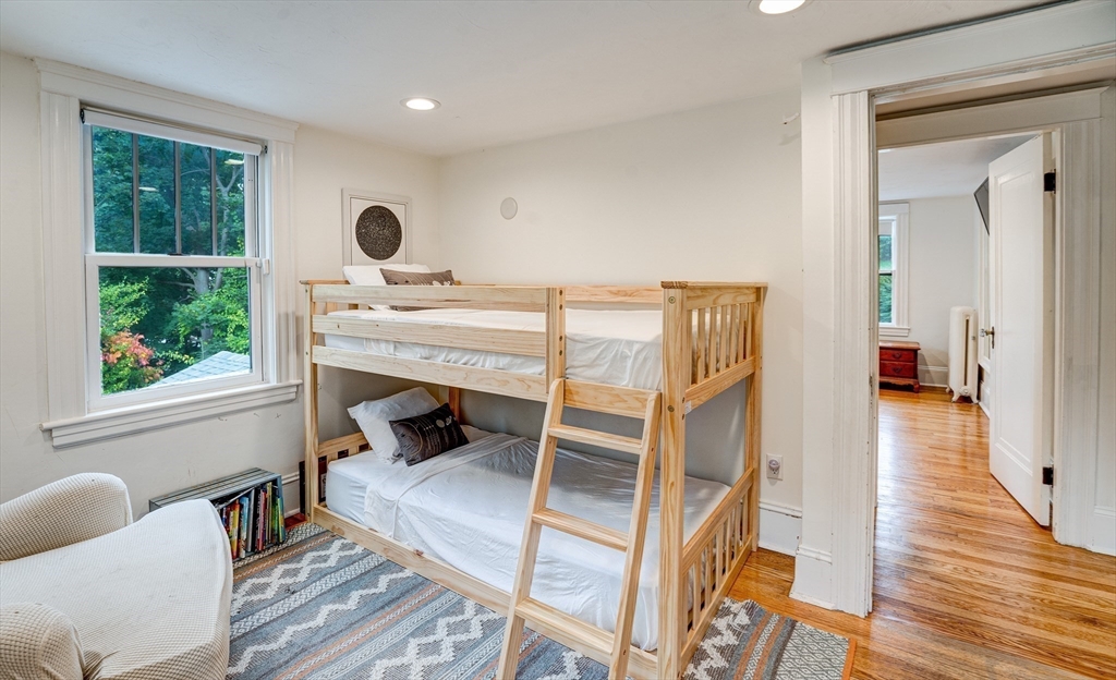 90 Main Street Acton, MA 01720 - Photo 25 of 38 a bedroom with furniture and a fireplace