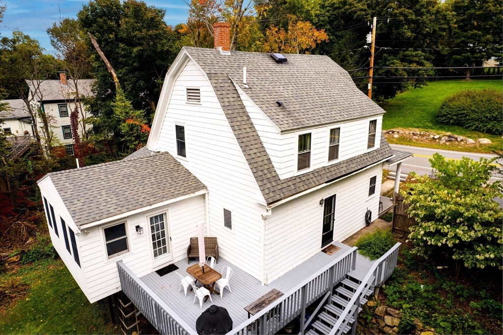 90 Main Street Acton, MA 01720 - Photo 32 of 38 a aerial view of a house with a yard