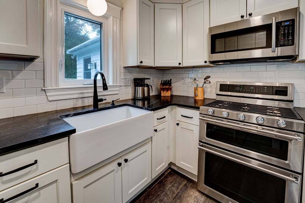 90 Main Street Acton, MA 01720 - Photo 6 of 38 a kitchen with stainless steel appliances a stove microwave and sink