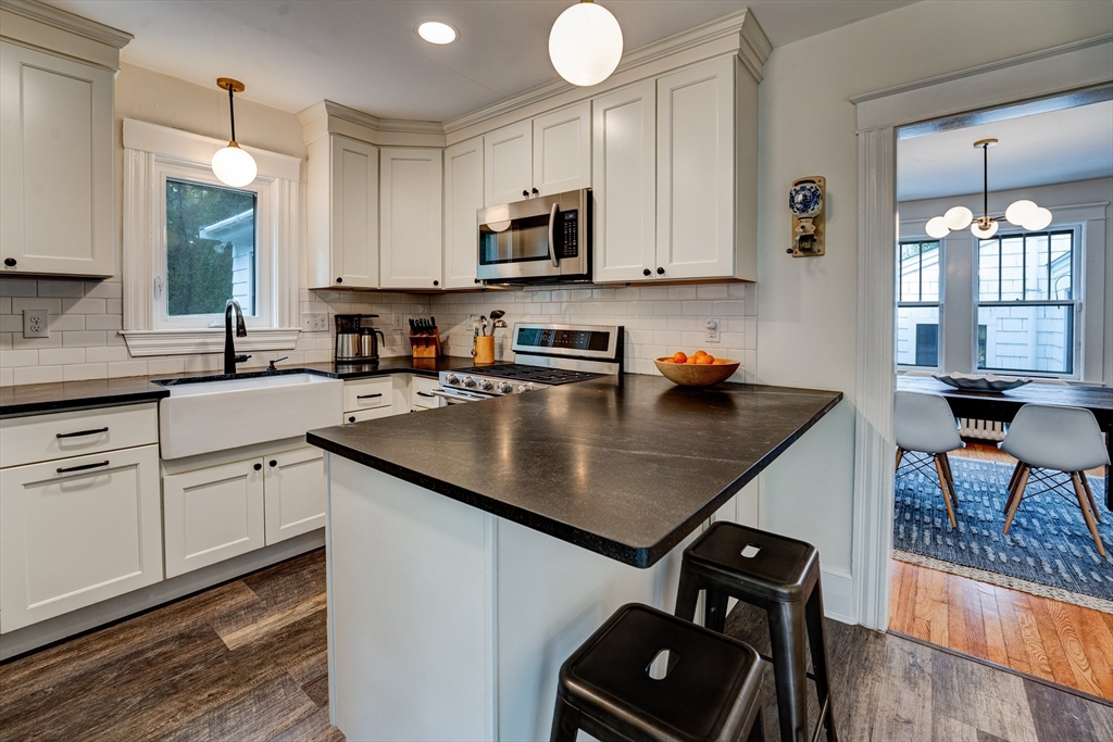 90 Main Street Acton, MA 01720 - Photo 7 of 38 a kitchen with stainless steel appliances a sink a stove a window and cabinets