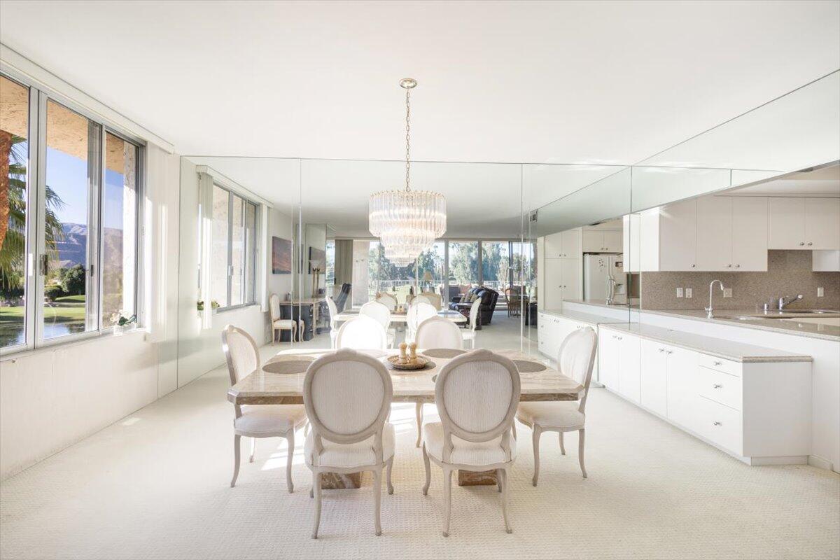 900 Island Drive, Unit 313 Rancho Mirage, CA 92270 - Photo 12 of 62 a dining room with furniture a chandelier and window