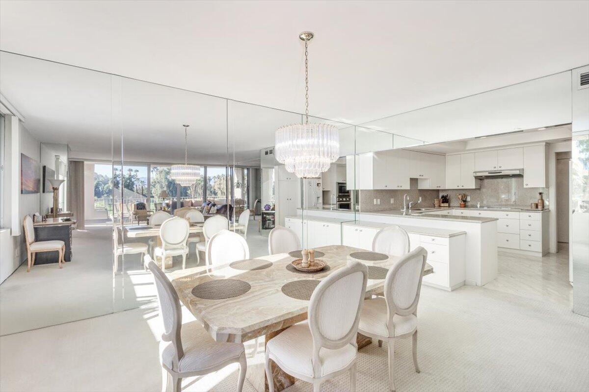 900 Island Drive, Unit 313 Rancho Mirage, CA 92270 - Photo 13 of 62 a dining room with furniture a chandelier and kitchen view