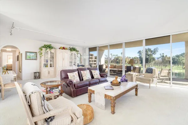 a dining room with furniture a chandelier and a rug