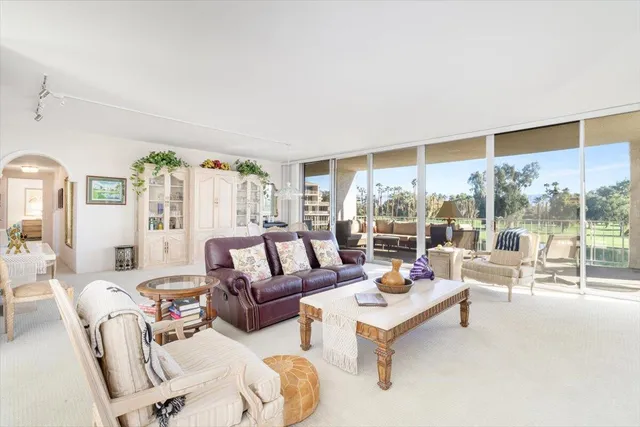 a dining room with furniture a chandelier and a rug