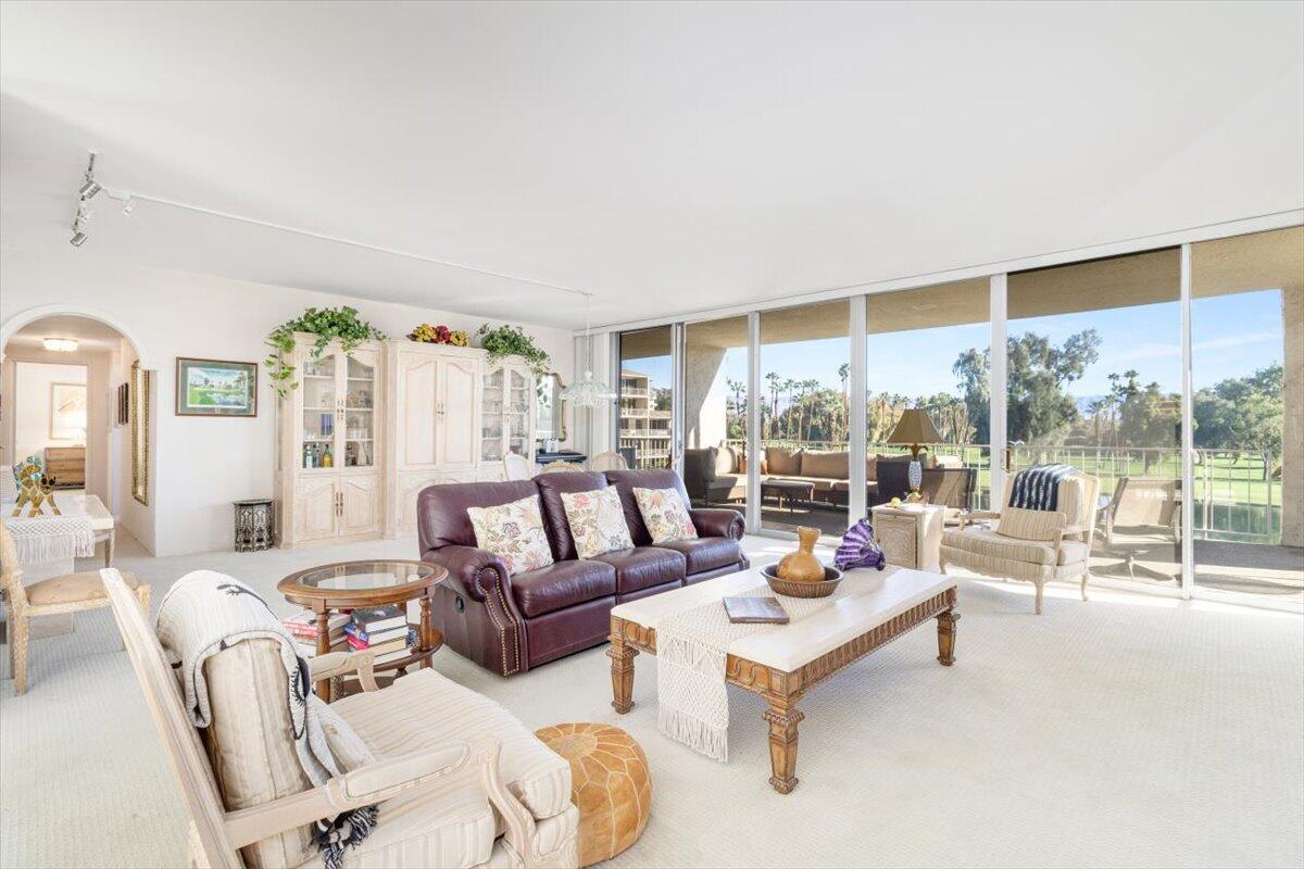 900 Island Drive, Unit 313 Rancho Mirage, CA 92270 - Photo 18 of 62 a living room with furniture and a large window