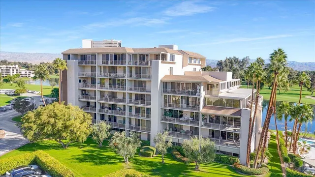 a front view of a residential apartment building with a yard