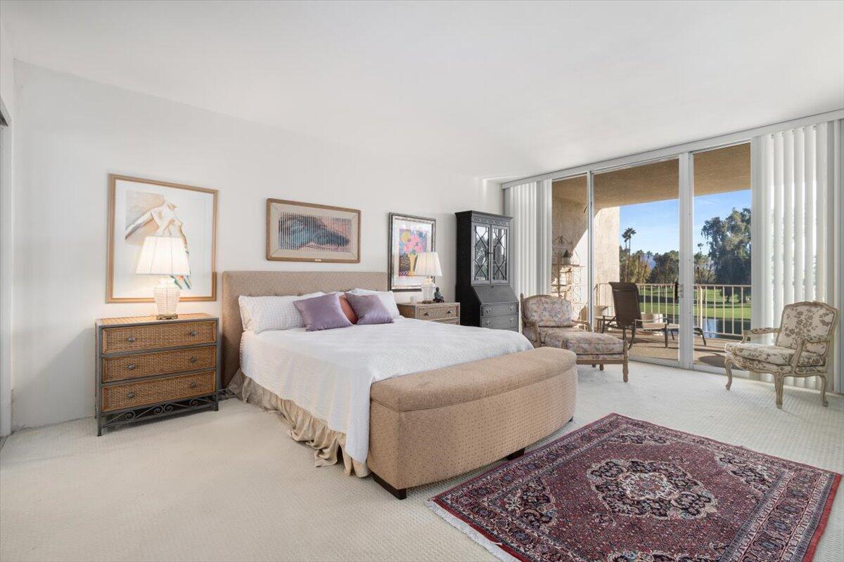 900 Island Drive, Unit 313 Rancho Mirage, CA 92270 - Photo 24 of 62 a bed room with a bed and a couch