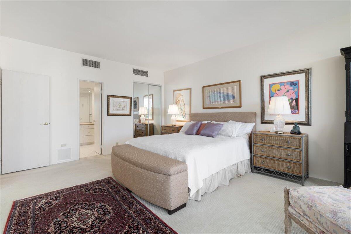 900 Island Drive, Unit 313 Rancho Mirage, CA 92270 - Photo 26 of 62 a bed room with a bed and a couch