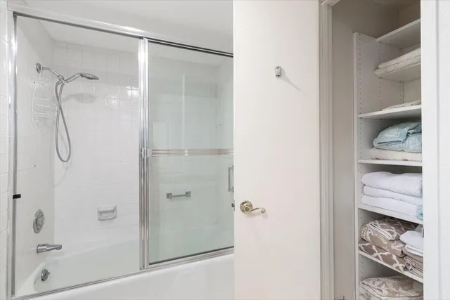 a bedroom with two beds and a large window