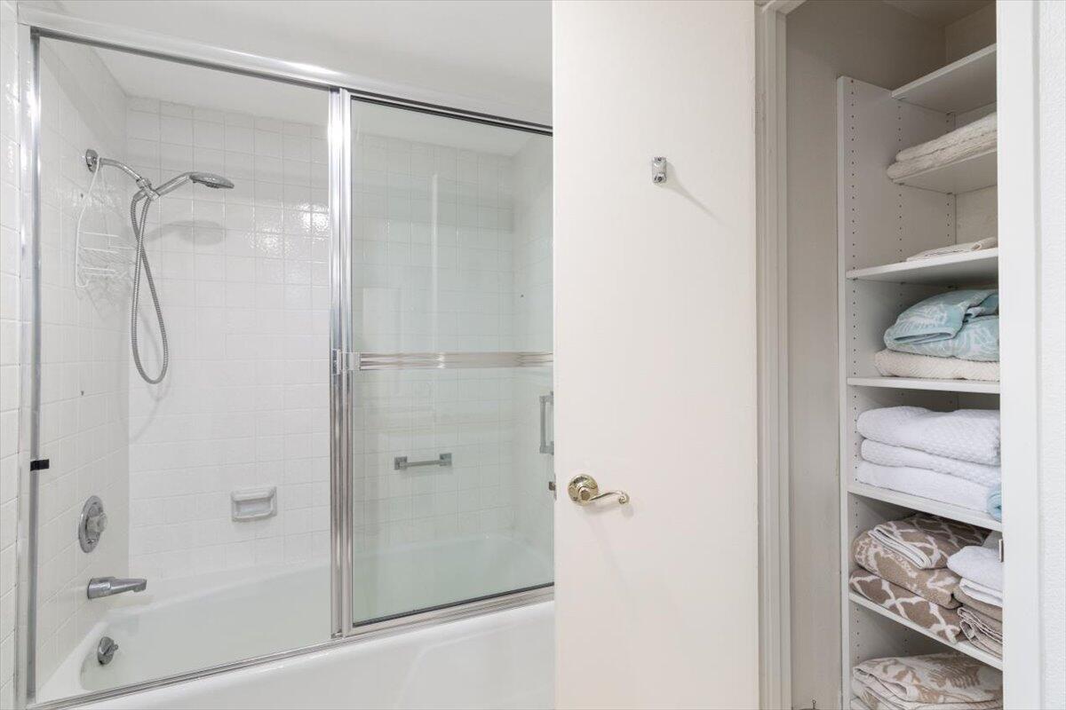 900 Island Drive, Unit 313 Rancho Mirage, CA 92270 - Photo 32 of 62 a bathroom with a glass shower door